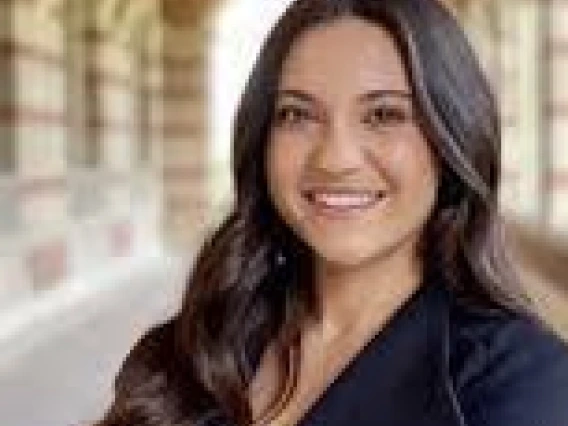 Decorative image of Megan Cracchiolo smiling. 