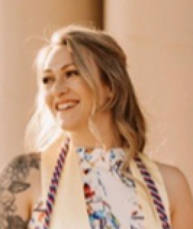 Decorative image of Caitlyn Flores smiling. 